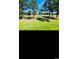 Scenic view of the golf course lined with mature trees and lush green grass, great for outdoor enthusiasts at 4669 Wild Iris Dr. # 22-2O2, Myrtle Beach, SC 29577