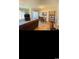 Cozy living room with wood flooring, a comfortable brown sofa, dining table, a 'Welcome' sign and natural light at 4669 Wild Iris Dr. # 22-2O2, Myrtle Beach, SC 29577