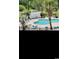 Community pool area with lounge chairs, palm trees, and a small pool house at 4669 Wild Iris Dr. # 22-2O2, Myrtle Beach, SC 29577