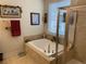 Bathroom featuring a garden tub, glass shower, decor, and natural light from the window at 505 Heartland Ct., Murrells Inlet, SC 29576