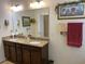 Bathroom with a double vanity, granite countertop, decor, and a large mirror with decorative lighting at 505 Heartland Ct., Murrells Inlet, SC 29576