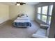 Bright bedroom showcasing neutral walls, large windows, and a cozy chair near a comfy bed at 505 Heartland Ct., Murrells Inlet, SC 29576