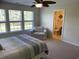 Comfortable bedroom featuring natural light, ceiling fan, and an adjacent bathroom entrance at 505 Heartland Ct., Murrells Inlet, SC 29576