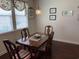 Cozy dining area with a wooden table, four chairs, window with blinds, and decor at 505 Heartland Ct., Murrells Inlet, SC 29576