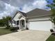 Charming home exterior with a covered porch and an attached two car garage at 505 Heartland Ct., Murrells Inlet, SC 29576