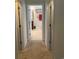 Neutral hallway with carpet, featuring open doorway to bathroom with tile floors and granite counters at 505 Heartland Ct., Murrells Inlet, SC 29576