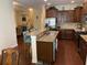 Modern kitchen featuring granite countertops, a large island with seating, stainless steel appliances, and dark wood cabinets at 505 Heartland Ct., Murrells Inlet, SC 29576