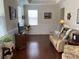 Comfortable living room featuring hardwood floors, wainscoting, a large window, and a recliner at 505 Heartland Ct., Murrells Inlet, SC 29576