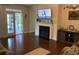 Cozy living room showcasing a fireplace, TV, and sliding glass doors to the porch at 505 Heartland Ct., Murrells Inlet, SC 29576