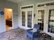 Inviting patio with stone flooring, casual seating, and views into an adjacent bathroom at 505 Heartland Ct., Murrells Inlet, SC 29576