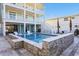 Inviting backyard pool with submerged loungers, stone accents, and an expansive patio area at 5203 N Ocean Blvd. N, North Myrtle Beach, SC 29582