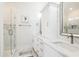 Elegant bathroom with a glass-enclosed shower, dual sinks with marble countertops, and white cabinets at 5203 N Ocean Blvd. N, North Myrtle Beach, SC 29582