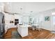Bright kitchen with an island, stainless steel appliances, white cabinets, pendant lighting, and an adjacent dining area at 5203 N Ocean Blvd. N, North Myrtle Beach, SC 29582
