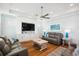 Well-lit living room featuring hardwood floors, recessed lighting, a ceiling fan, and a built-in entertainment unit at 5203 N Ocean Blvd. N, North Myrtle Beach, SC 29582