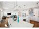 Open-concept living area featuring a kitchen, dining table, and living room with modern lighting and hardwood floors at 5203 N Ocean Blvd. N, North Myrtle Beach, SC 29582