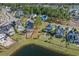 An aerial view showing a vacant lot, outlined in red, in a well-established waterfront community with mature trees at 573 Starlit Way, Myrtle Beach, SC 29579