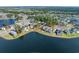 An aerial view shows a lakeside home in a gated community with lush landscaping and water views at 573 Starlit Way, Myrtle Beach, SC 29579
