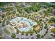 An aerial view showcases a luxurious community pool with a lazy river and many lounge areas at 573 Starlit Way, Myrtle Beach, SC 29579