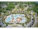 An aerial view showcases a luxurious community pool with a lazy river and many lounge areas at 573 Starlit Way, Myrtle Beach, SC 29579