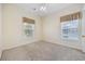 Bedroom features two windows offering natural light and neutral walls, and carpeted floors at 5882 Longwood Dr. # 201, Murrells Inlet, SC 29576