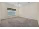 Bedroom features a window with a view, neutral walls, carpeted floors, and a ceiling fan at 5882 Longwood Dr. # 201, Murrells Inlet, SC 29576
