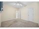 Bedroom with neutral walls, carpeted floors, closet, entry into the en suite, and ceiling fan at 5882 Longwood Dr. # 201, Murrells Inlet, SC 29576