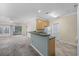Open kitchen with a breakfast bar that connects to the living area and sliding glass doors at 5882 Longwood Dr. # 201, Murrells Inlet, SC 29576