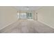 Bright living room featuring neutral walls, carpet, and sliding glass doors to the exterior at 5882 Longwood Dr. # 201, Murrells Inlet, SC 29576