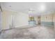 Spacious living room boasts neutral walls, carpet, and an open layout flowing into the kitchen at 5882 Longwood Dr. # 201, Murrells Inlet, SC 29576