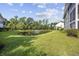 Well-manicured lawn near a pond with a fountain as a focal point at 5882 Longwood Dr. # 201, Murrells Inlet, SC 29576