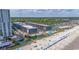 Aerial shot of beachside resort showcasing the pools and buildings under a clear sky at 5905 S Kings Hwy. # 404 A, Myrtle Beach, SC 29575