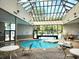 Indoor pool with glass ceiling and comfortable seating area at 5905 S Kings Hwy. # 404 A, Myrtle Beach, SC 29575