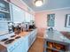 Bright kitchen with white cabinets, essential appliances and cozy breakfast bar at 5905 S Kings Hwy. # 404 A, Myrtle Beach, SC 29575