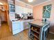Bright kitchen with white cabinets, essential appliances and a cozy breakfast bar and decorations at 5905 S Kings Hwy. # 404 A, Myrtle Beach, SC 29575