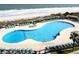 Large outdoor pool with lounge chairs and access to the beach at 5905 S Kings Hwy. # 404 A, Myrtle Beach, SC 29575