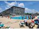 Large outdoor pool with lounge chairs and surrounding complex at 5905 S Kings Hwy. # 404 A, Myrtle Beach, SC 29575