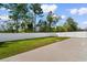 Spacious backyard featuring a well-maintained lawn, concrete patio, and privacy fence at 591 Meadowgrass Ct., Myrtle Beach, SC 29588