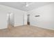 Primary bedroom with ceiling fan, carpet floors, and a view to the bathroom at 591 Meadowgrass Ct., Myrtle Beach, SC 29588