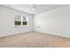 A bedroom with carpet floors and a large window provides ample natural light at 591 Meadowgrass Ct., Myrtle Beach, SC 29588