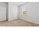 Well-lit bedroom with neutral carpet, a bright window, and a closet door for storage at 591 Meadowgrass Ct., Myrtle Beach, SC 29588