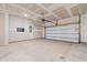 Spacious two-car garage with overhead door, electrical panel, and ample lighting at 591 Meadowgrass Ct., Myrtle Beach, SC 29588