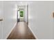 Clean hallway with wood-look flooring leading to a naturally lit doorway at 591 Meadowgrass Ct., Myrtle Beach, SC 29588