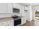 Modern kitchen with white cabinets, granite countertops, and stainless steel appliances at 591 Meadowgrass Ct., Myrtle Beach, SC 29588