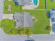 Aerial view showcases a home with a large yard, mature trees, and an expansive roof at 6000 Isabel Ct., Myrtle Beach, SC 29579