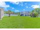 Expansive backyard with lush green grass, a white fence, and mature trees, providing a serene outdoor space at 6000 Isabel Ct., Myrtle Beach, SC 29579
