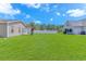 Large, grassy backyard enclosed by a white fence, offering ample space for outdoor activities and relaxation at 6000 Isabel Ct., Myrtle Beach, SC 29579
