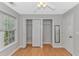 Bright bedroom featuring a ceiling fan, window, and closet with folding doors at 6000 Isabel Ct., Myrtle Beach, SC 29579