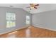 Spacious bedroom with ceiling fan, hardwood floors, and windows providing natural light at 6000 Isabel Ct., Myrtle Beach, SC 29579
