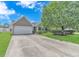 Charming home with lush green lawn, mature landscaping, and a spacious driveway leading to the garage at 6000 Isabel Ct., Myrtle Beach, SC 29579