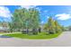 Landscaped front yard with lush green grass, mature trees, and clear signage at 6000 Isabel Ct., Myrtle Beach, SC 29579